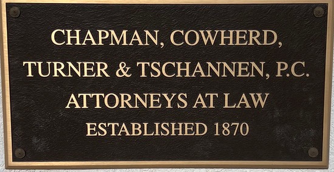 Bronze plaque reading Chapman, Cowherd, Turner & Tschannen, P.C., Attorneys at Law, Established 1870